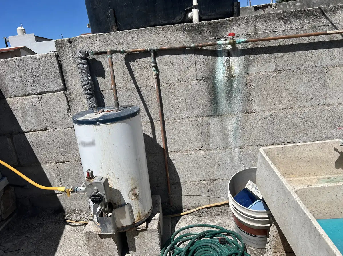 Tubería de cobre bajo un calentador de agua.